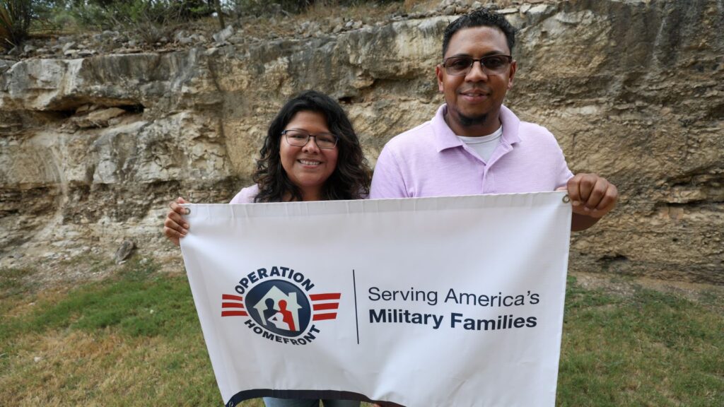 Military family holding an Operation Homefront sign.
