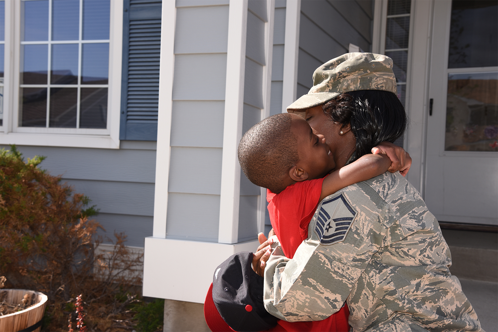 U.S. Air Force Master Sgt. Lateisha Nunn kneeling down and hugging her son.