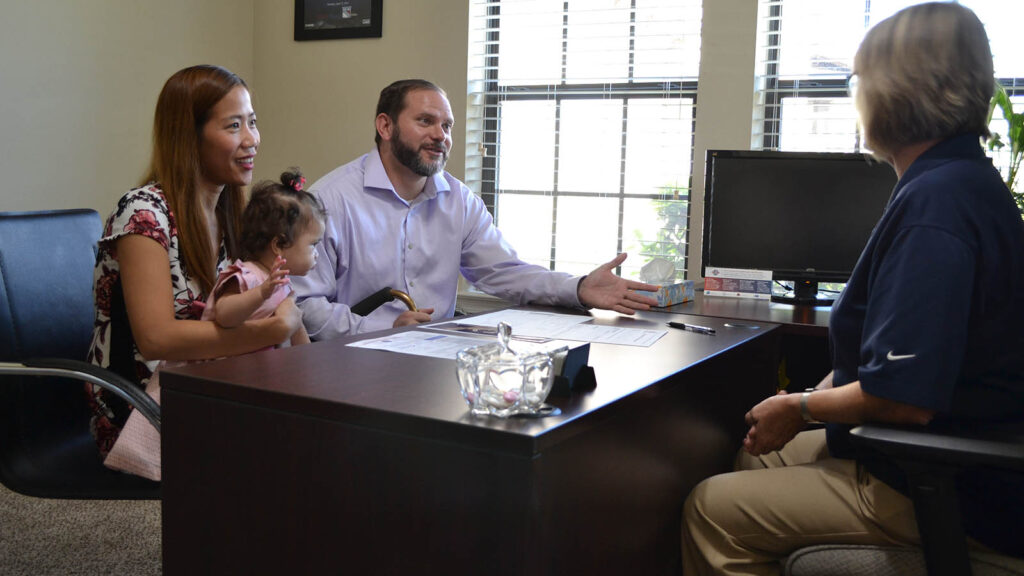 Photo of a family meeting with someone else in an office.