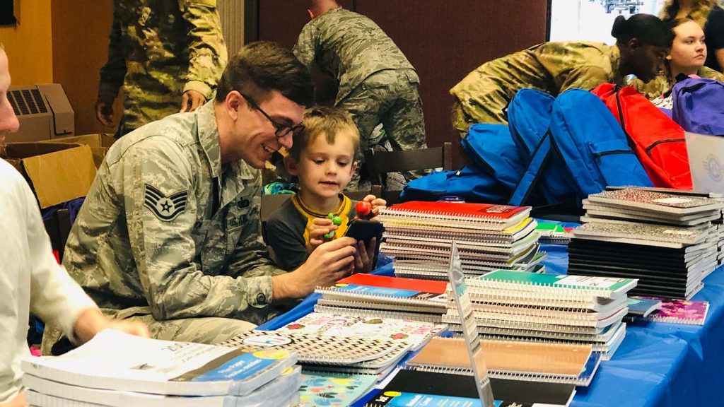 Service member viewing back to school free supplies.