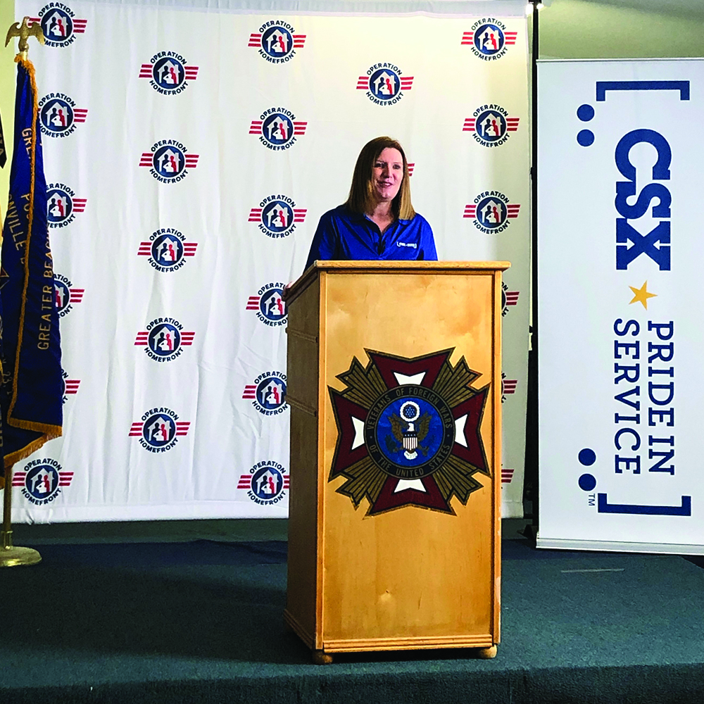 Woman speaking at a podium.