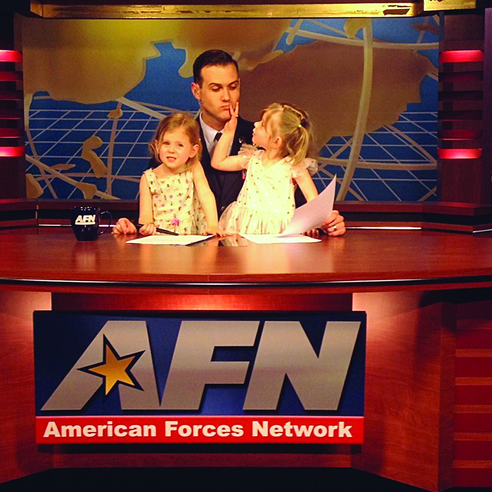 Service member brings his daughters to work at news station.