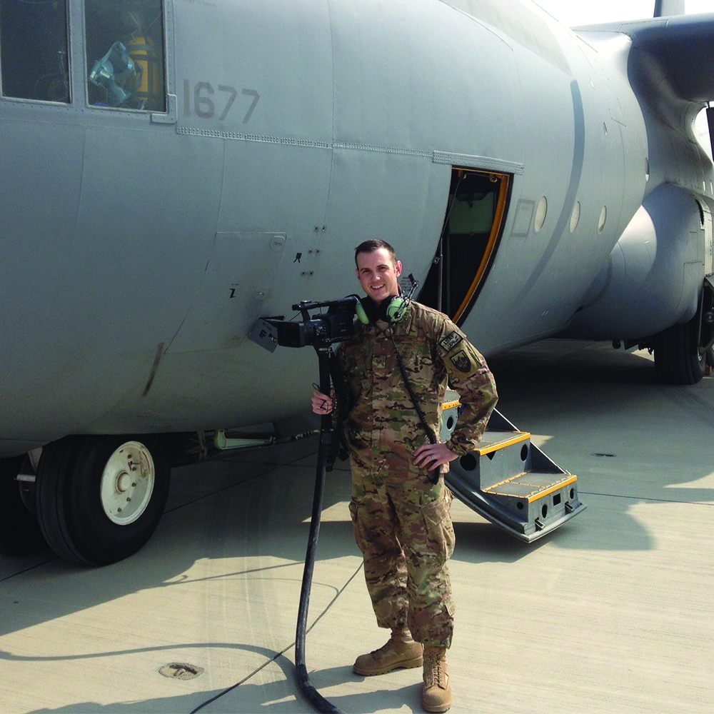 Career Airforce soldier standing next to cargo plane.