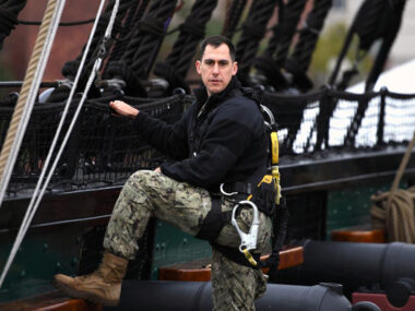Navy soldier on ship with gear.