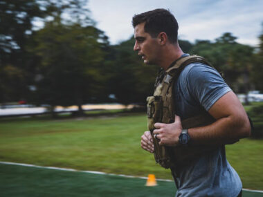 Military soldier running with weight vest.
