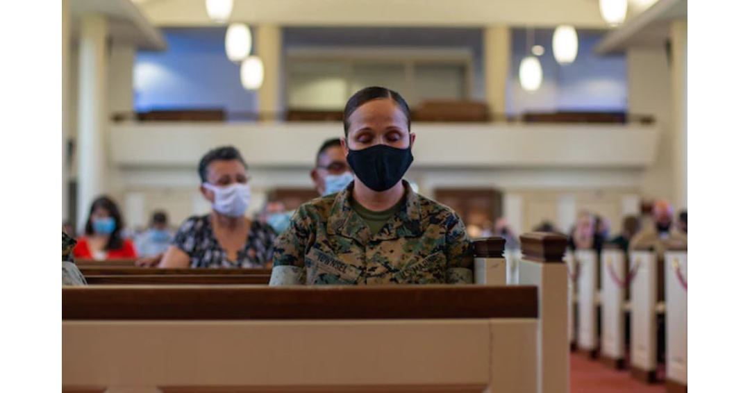 Female marine soldier sitting in church.