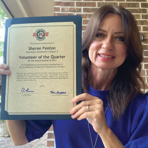 Operation Homefront volunteer holding an award.