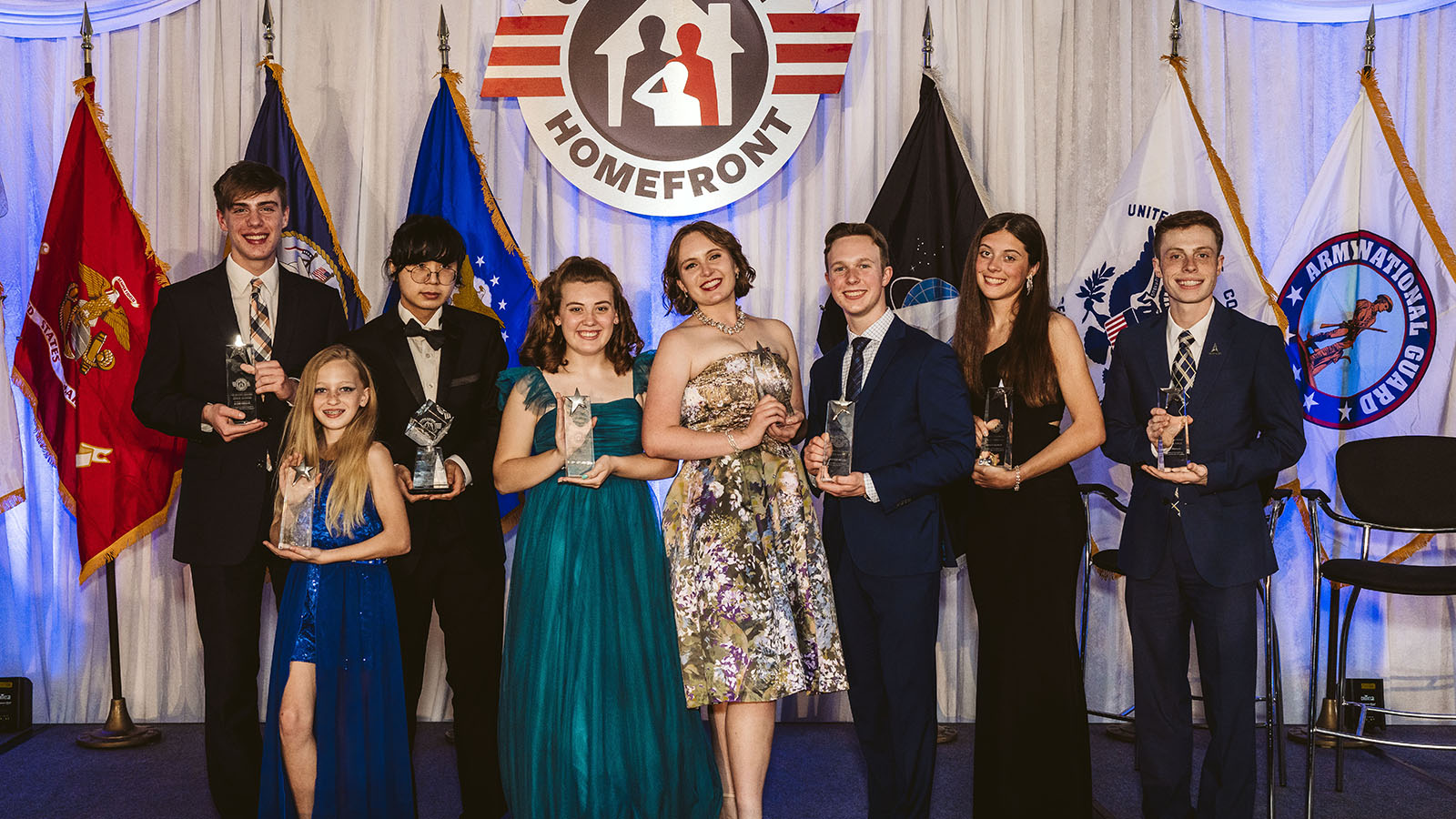 2022 Military Child of the Year Recipients on stage holding their awards.