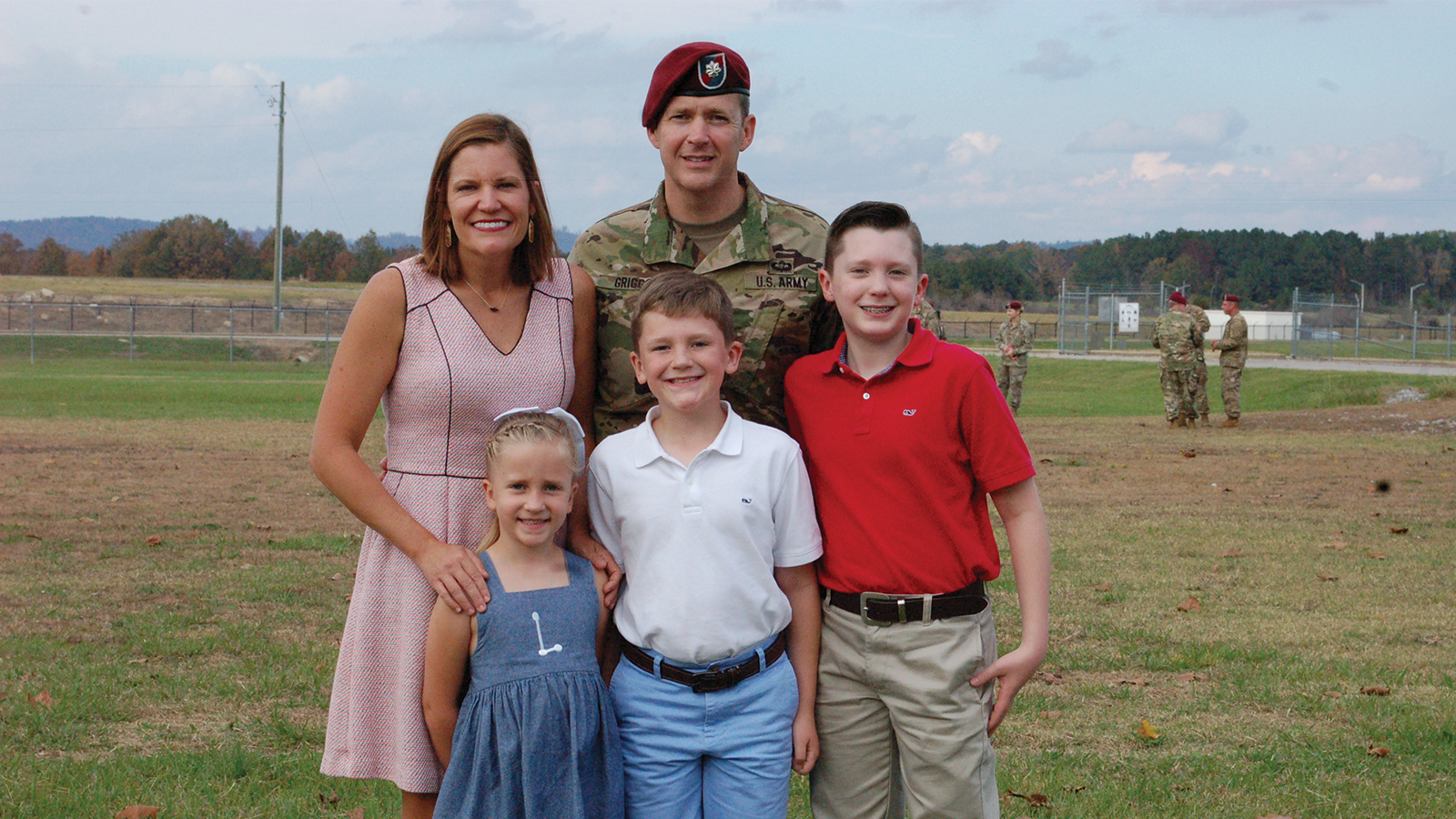 Military family standing on a field