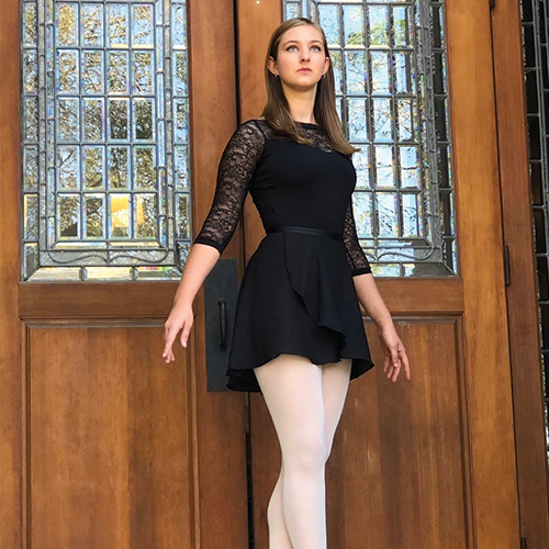 ballerina standing in front of a door