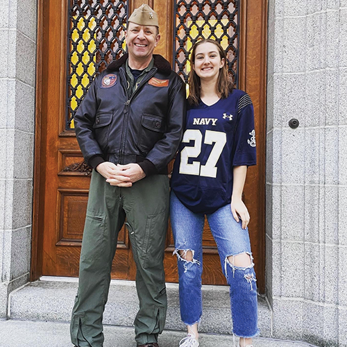 father and daughter standing on stairs