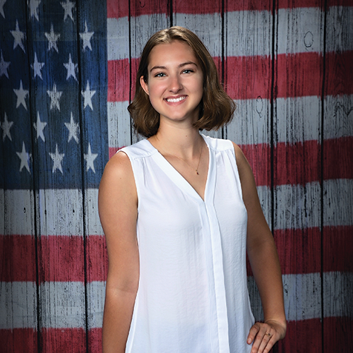 girl standing in front od an American flag background