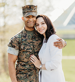 Marine veteran and his wife hugging and smiling