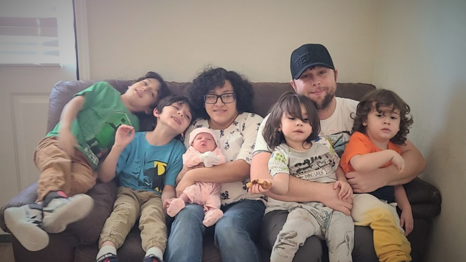 A family sitting on a couch