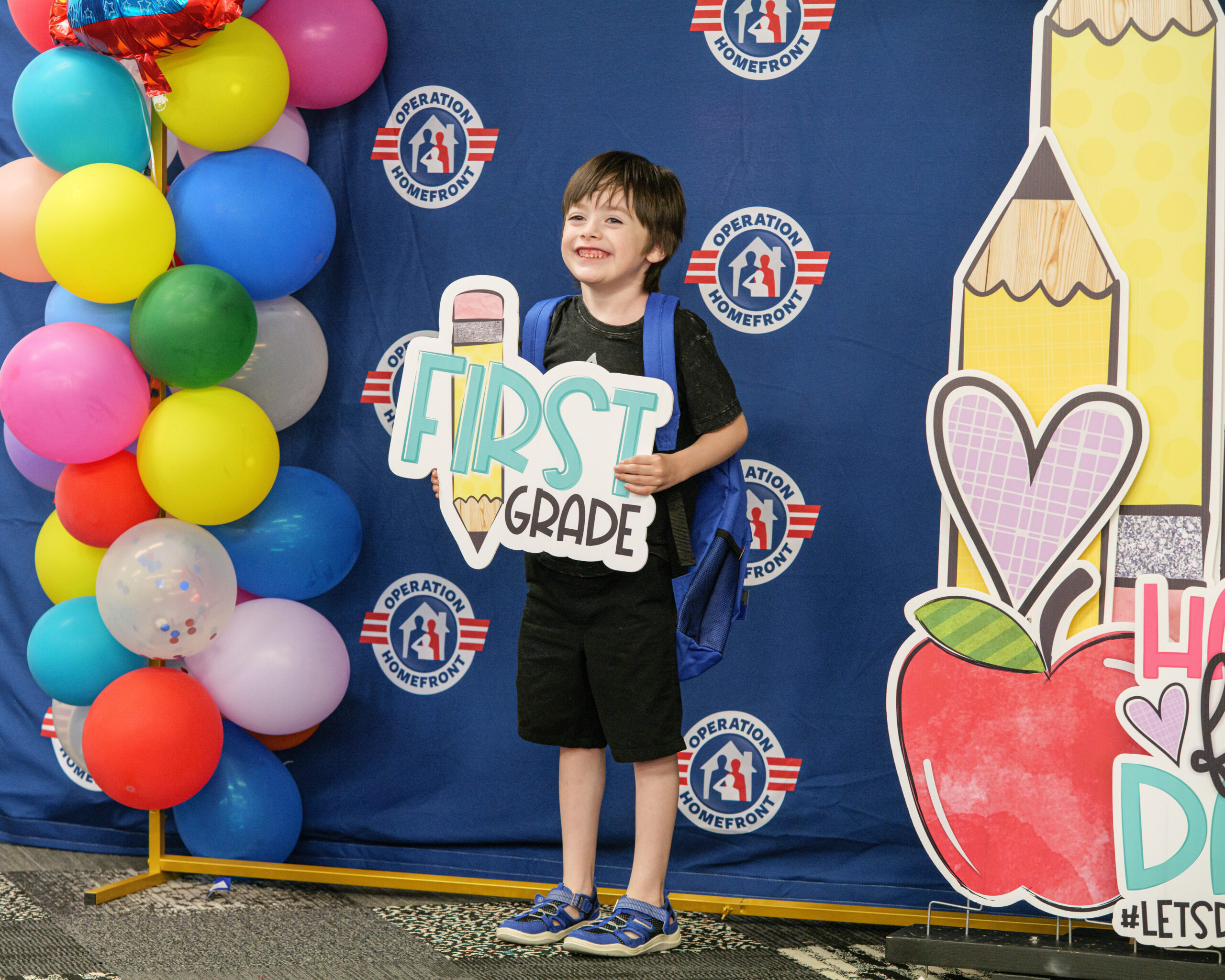 boy holding a first grade sign for a photo