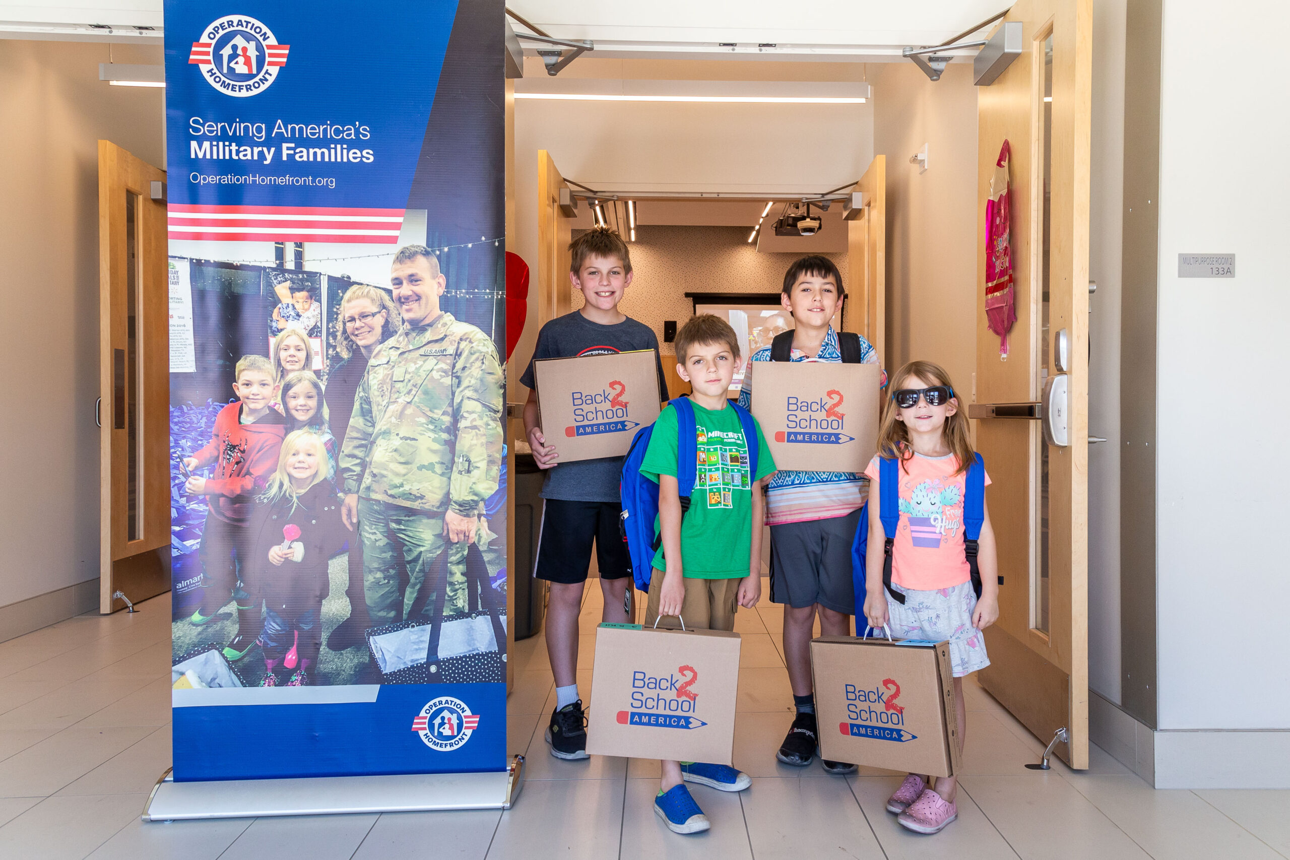 children with school supplies at operation homefront event