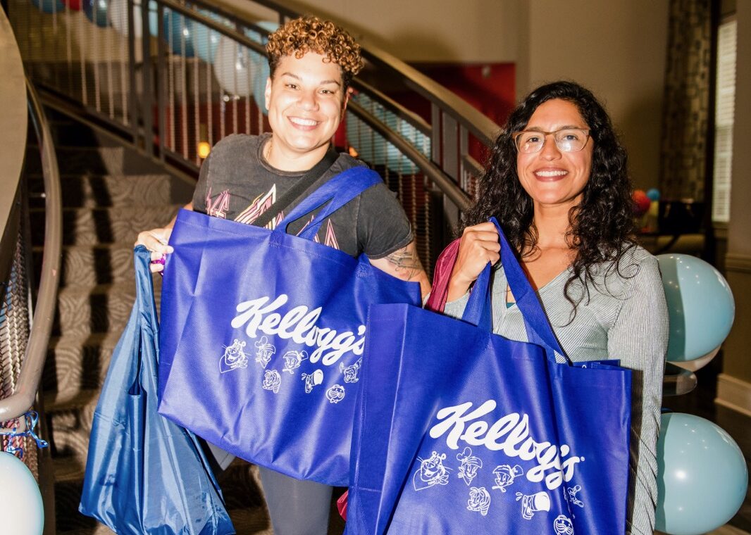 two woman holding kelloggs swag bags