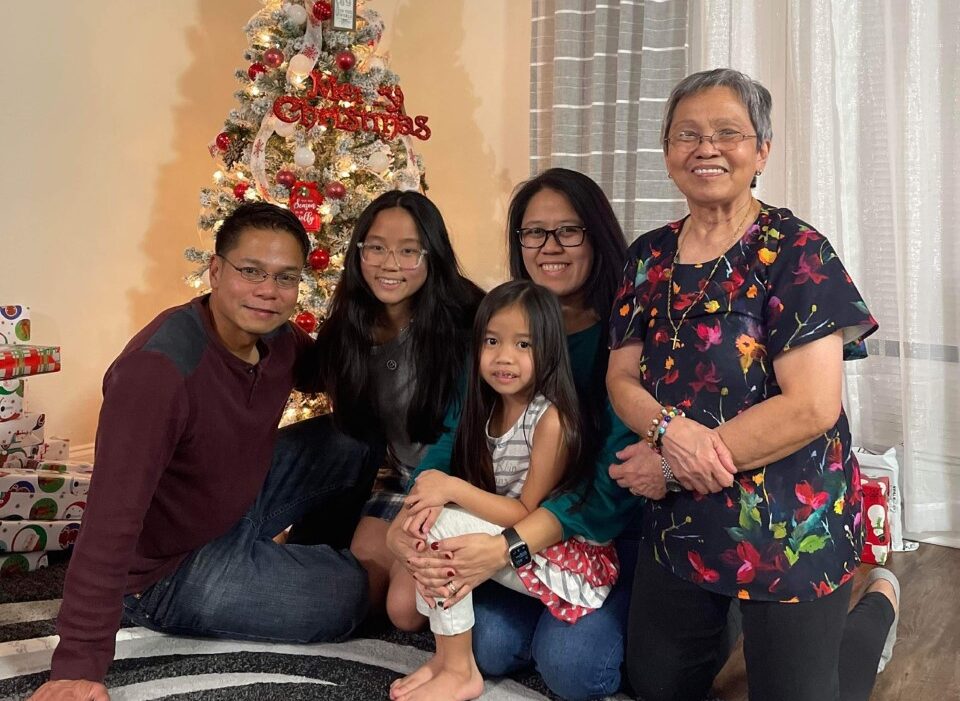 family in front of christmas tree