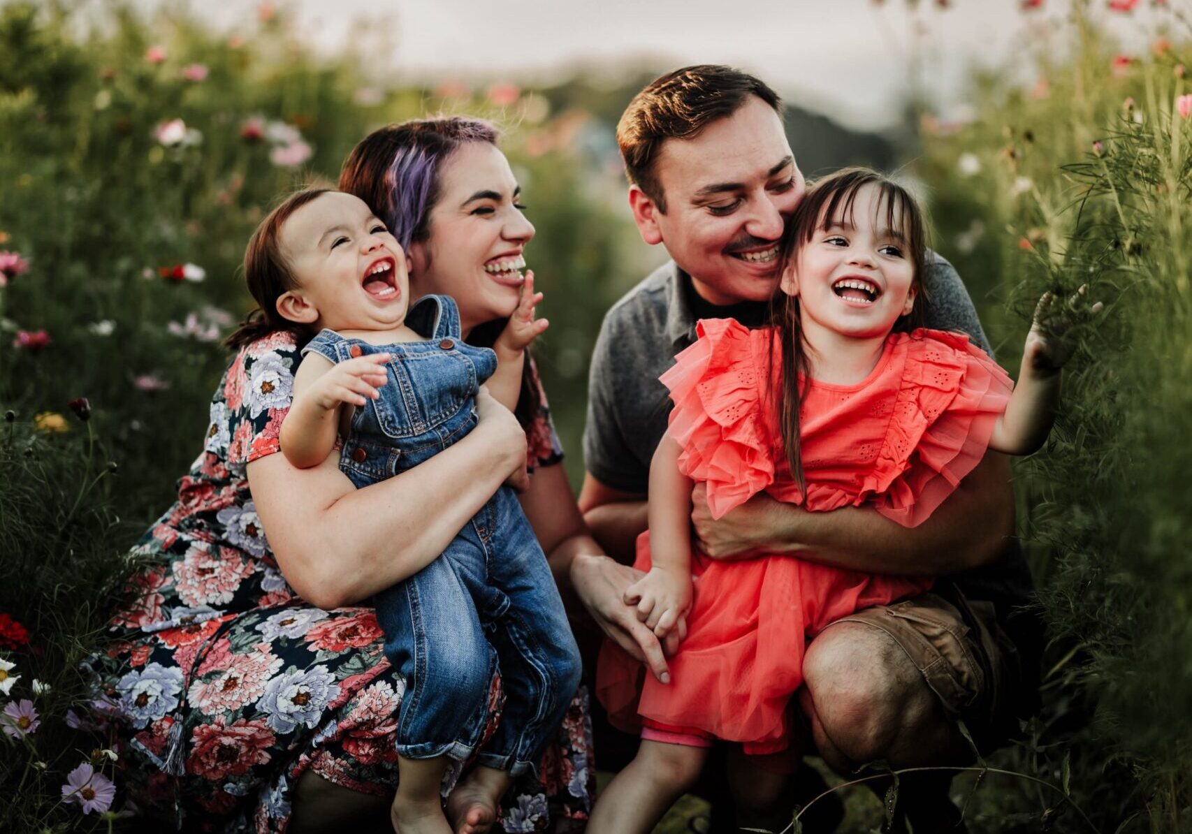 family laughing with parents and two children