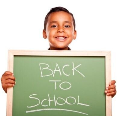 child with back to school sign